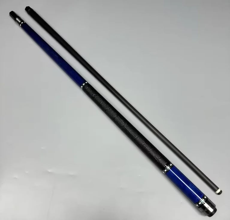 Two pool cues with black shafts and blue handles positioned diagonally on a light gray background